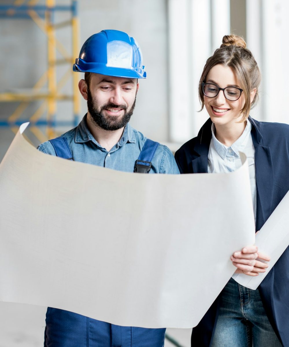 Builder with businesswoman at the construction site